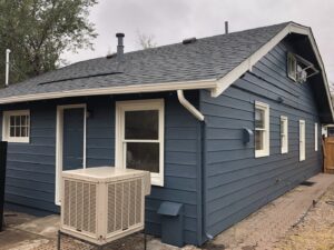 A completed house exterior renovation with new siding, roof, and gutters by Deep Roots Craftsmen in Fort Collins, CO.