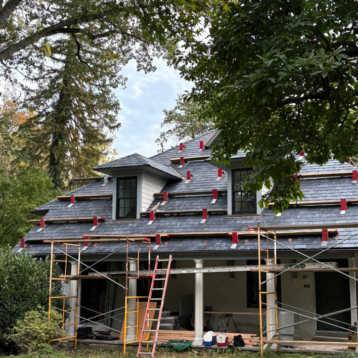 House exterior roof renovation with scaffolding and new shingles by Alloway Construction & Restoration Inc in Skillman, NJ