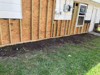 House exterior with siding removed, exposing studs for foundation repair by Complete Foundation Repairs in Corpus Christi, TX.