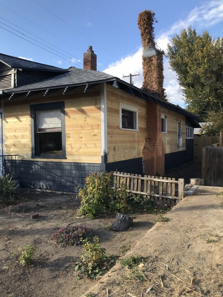 Exterior of a house showing new wood siding and painted foundation, completed by FES handyman services LLC in Boise, ID.