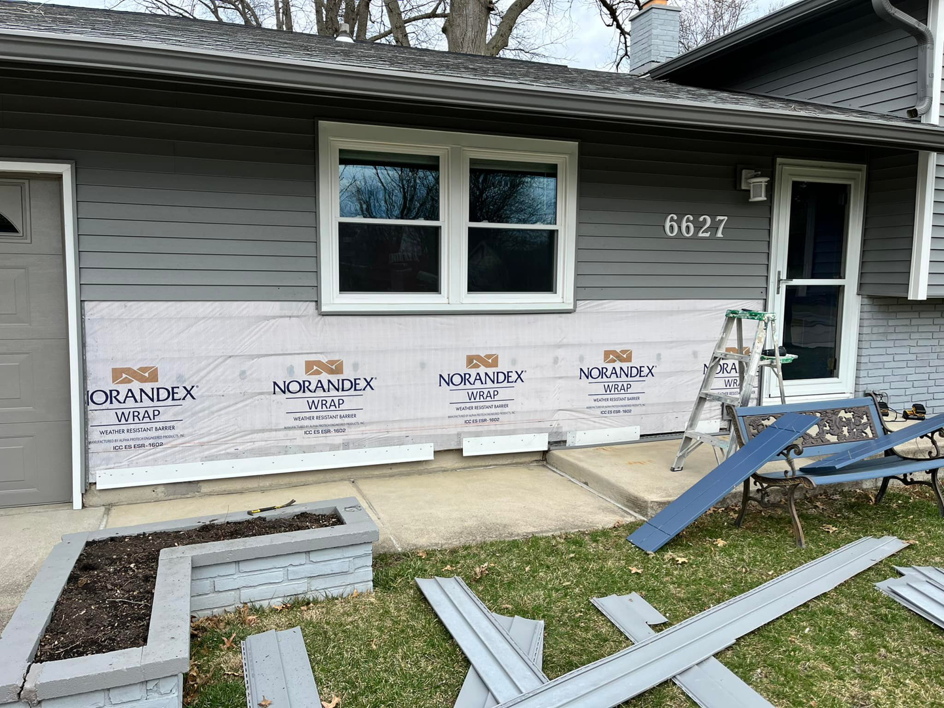 A house exterior during siding replacement, showing weather wrap installed by Lambert's Residential Painting And More LLC in Fort Wayne, IN.