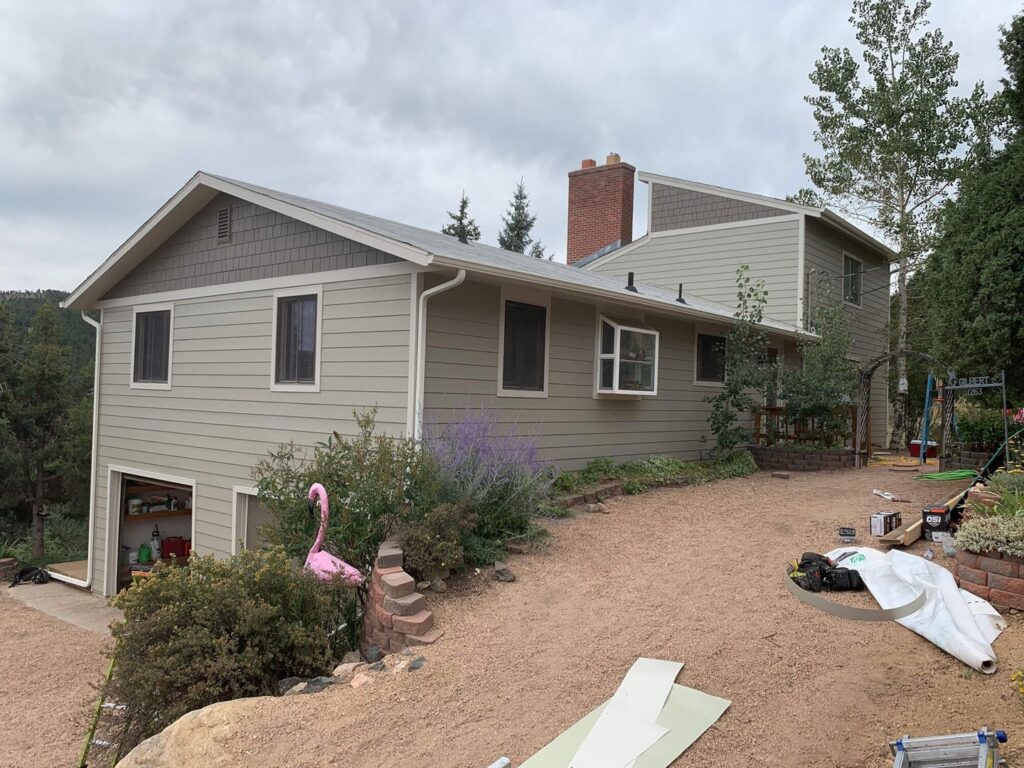 House exterior showing new siding and window replacement by Colorado Window Solutions in Denver, CO.