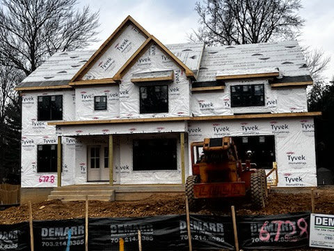 Exterior of a house under construction with Tyvek wrap by Quaker Custom Homes, LLC in Woodbridge, VA