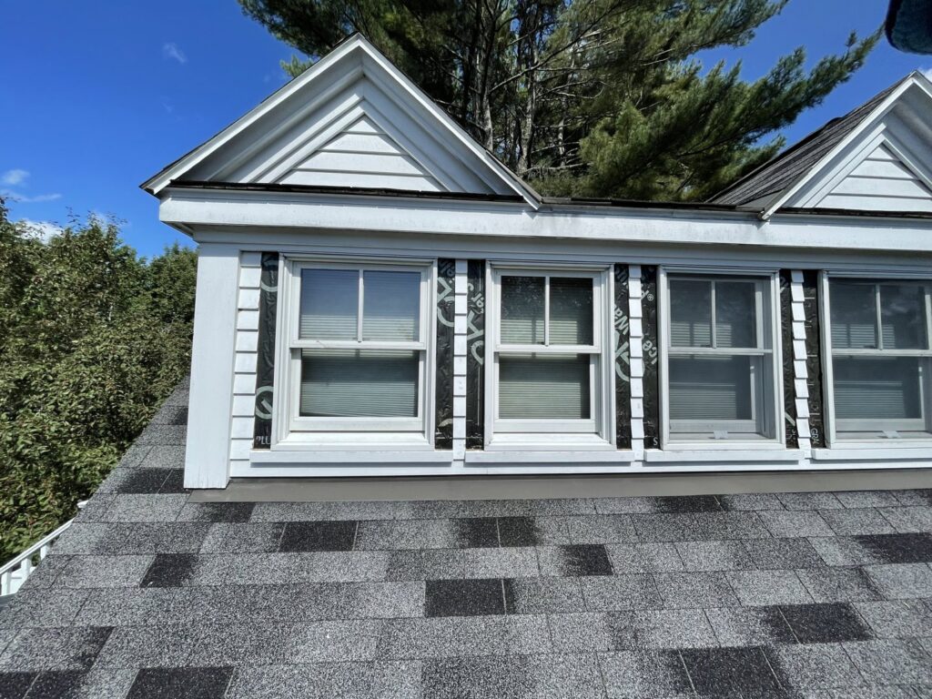 House exterior showing window and siding repair or installation in progress, by Sini's Handyman Services in Falmouth, ME.