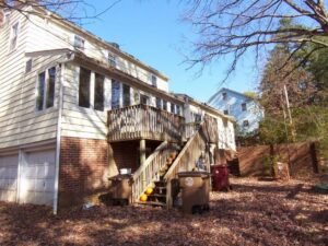 The exterior of a house featuring a multi-level wooden deck and stairs, completed by Rice Building Company in Rocky Mount, NC.