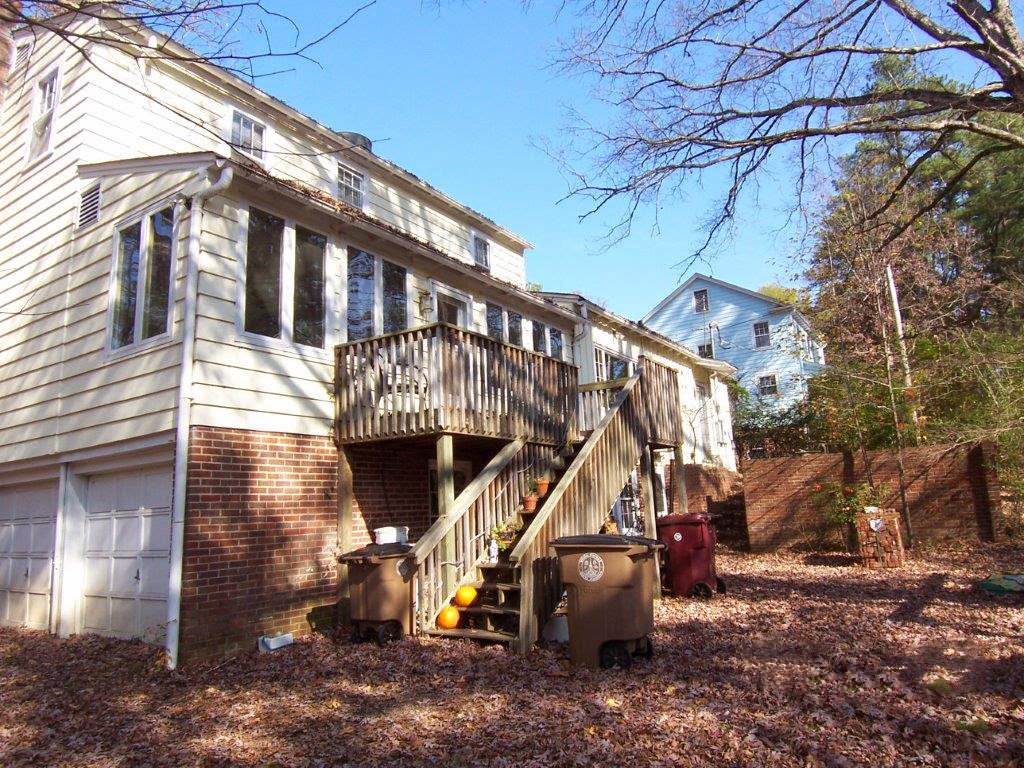 The exterior of a house featuring a multi-level wooden deck and stairs, completed by Rice Building Company in Rocky Mount, NC.