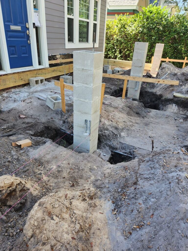 House foundation construction with concrete block pillars and excavated ground by Alejandro Melo Contractor corp in Tampa, FL.