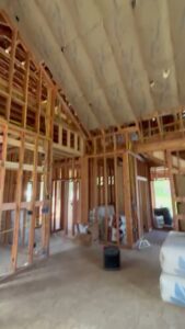 Interior view of a house under construction with exposed framing, prepared for insulation by Pacific Insulation & Mold Remediation in Spokane, WA.
