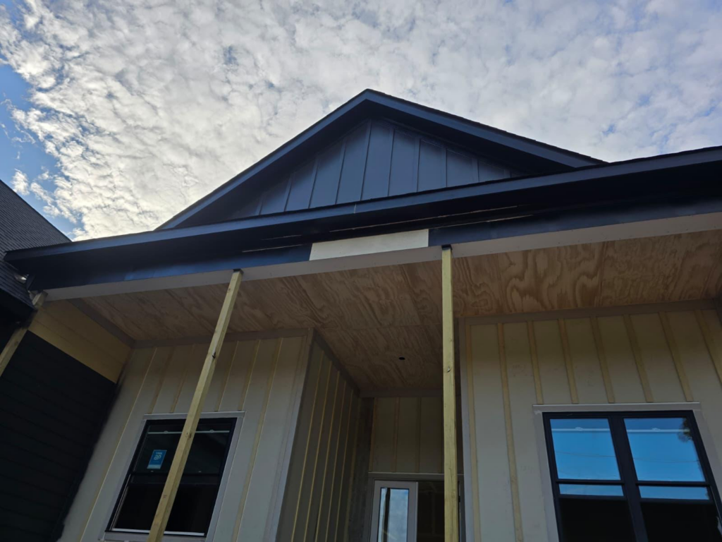 Front exterior of a house under construction with porch and siding by MAF Construction LLC in Raleigh, NC