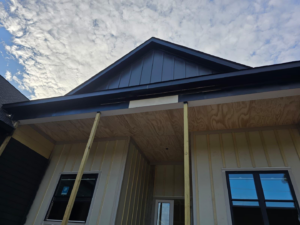 Front exterior of a house under construction with porch and siding by MAF Construction LLC in Raleigh, NC