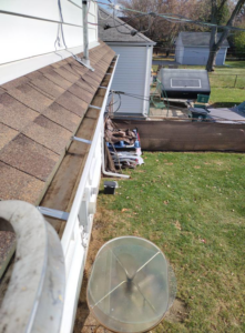 An overhead view of a house gutter and roof, showing the scope of exterior property services offered by Schu Can Do 2-Property Services LLC in Warren, MI.