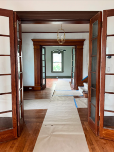 An interior view of a house with floors protected for renovation by Cambridgeport Construction in Milton, MA