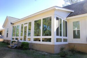 An impressive large sunroom addition on the side of a house, expertly built by NRG Industries in Tallahassee, FL.
