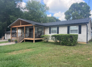 House with a new roof, gutters, and a newly built porch by Knoxville Guttering and Home Improvements in Knoxville, TN.