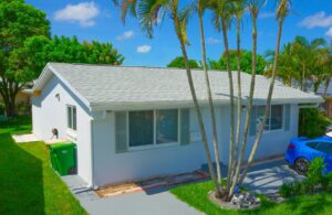 A renovated house with a new roof and windows, completed by FHIA Remodeling in Fort Lauderdale, FL
