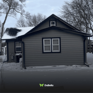 A house with new siding and windows completed by DaBella, standing out in the winter landscape in Minneapolis, MN.