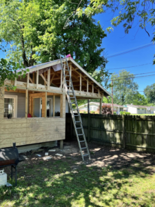 Exterior view of a house undergoing remodeling with new roof framing and siding by R&R Foundation and remodeling in Owensboro, KY