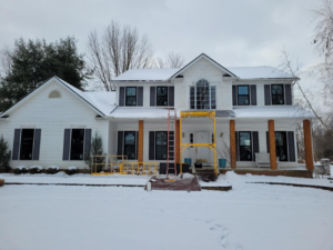 House exterior with scaffolding and ladders set up for a renovation project by 1st Choice Windows in Canton, OH.