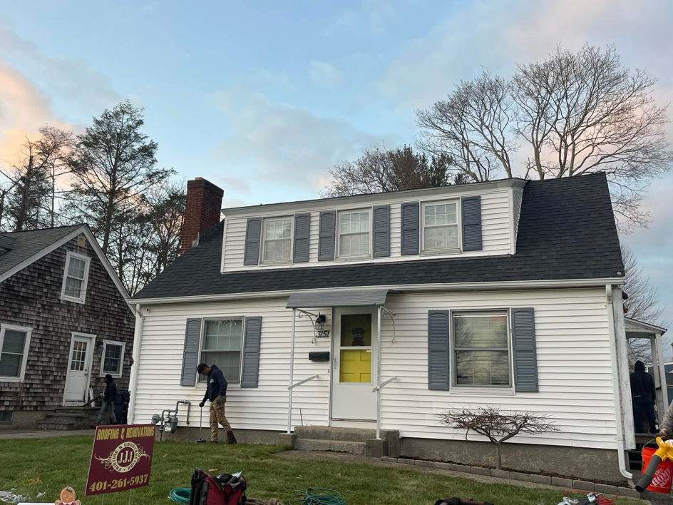 A house undergoing roofing and renovation work by JJJ Painting & Construction in Johnston, RI.