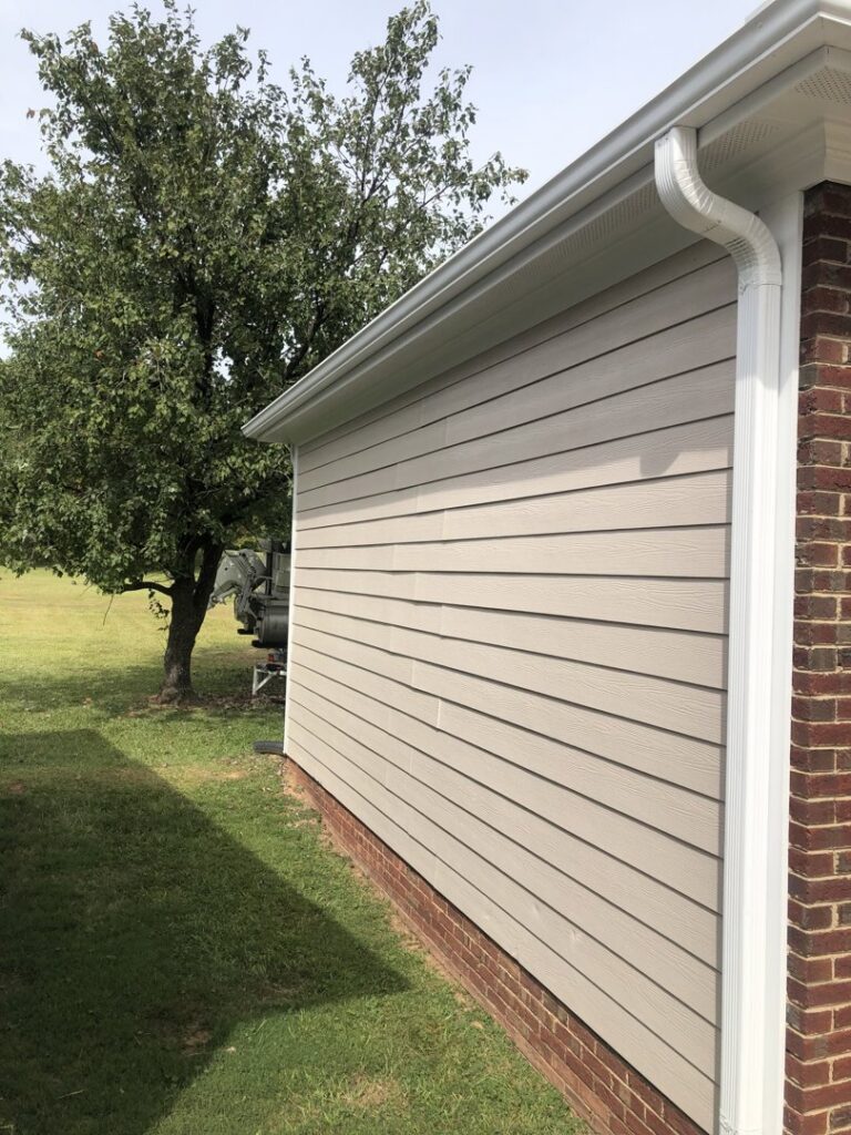 Freshly installed house siding and gutters on a home exterior by Lee's Painting in Northbrook, IL