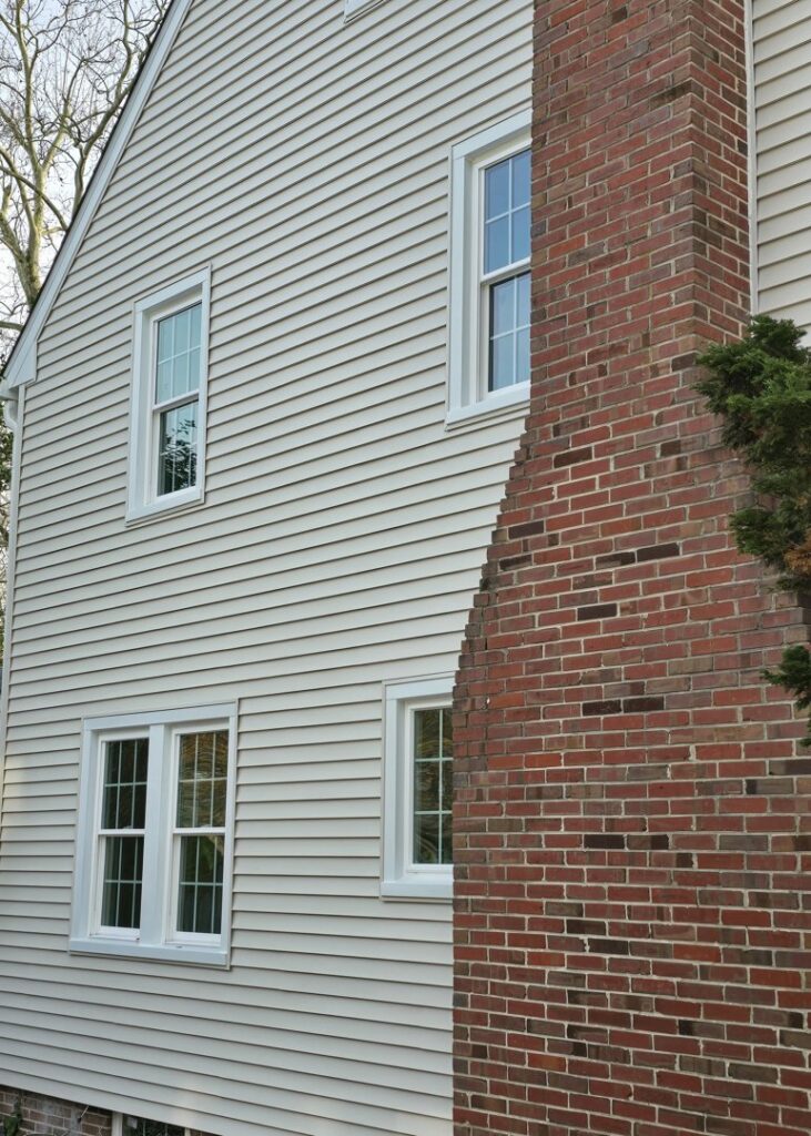 House exterior with new siding and a brick chimney by M. Phippin Contracting in Hebron, MD.
