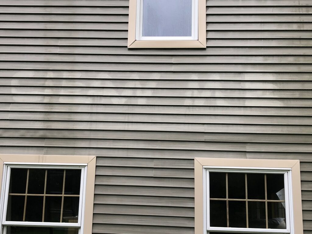 Exterior house siding showing dirt and grime, ready for cleaning by Phoenix's Cleaning Service, LLC in Rutland, VT.