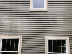 Exterior house siding showing dirt and grime, ready for cleaning by Phoenix's Cleaning Service, LLC in Rutland, VT.