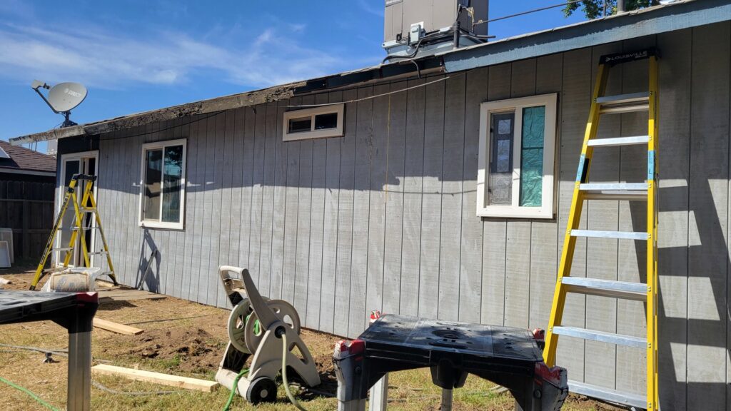 Exterior house siding installation in progress with ladders and tools by My Quality Handyman in Fresno, CA.