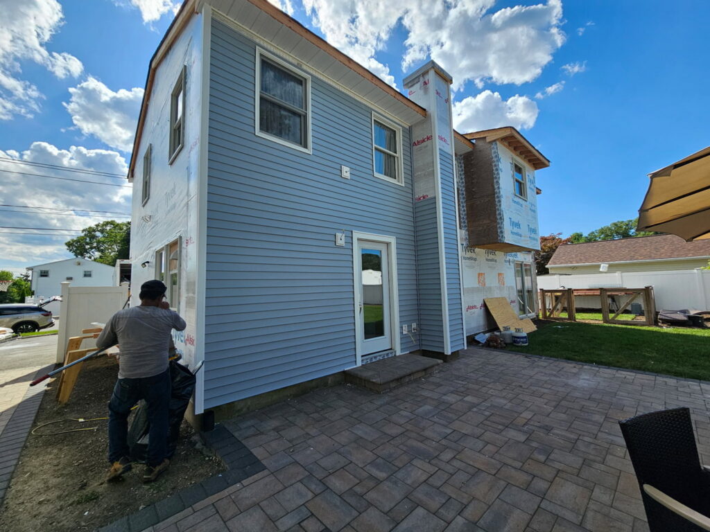 Exterior of a house undergoing siding installation and renovation by Universal Builders LLC in New Haven, CT.