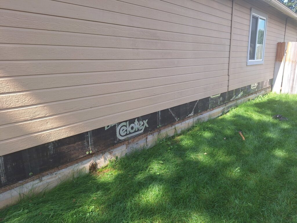 The side of a house with siding removed for repair or replacement, demonstrating handyman services by Fix Idaho LLC in Meridian, ID.