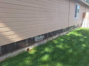 The side of a house with siding removed for repair or replacement, demonstrating handyman services by Fix Idaho LLC in Meridian, ID.