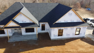 A house under construction with a newly installed shingle roof and Tyvek wrap by SJL Contracting, LLC in Owensboro, KY.