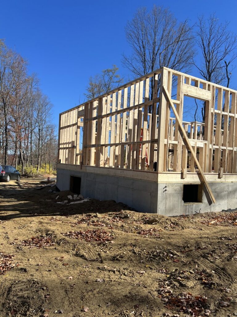 Interior view of house wall framing during new construction by LCM FRAMING LLC in Danbury, CT