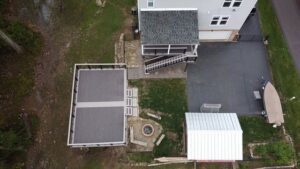 An aerial view of a house showcasing a newly built composite deck and outdoor living space by McIntyre's Renovations LLC in Pittsburgh, PA