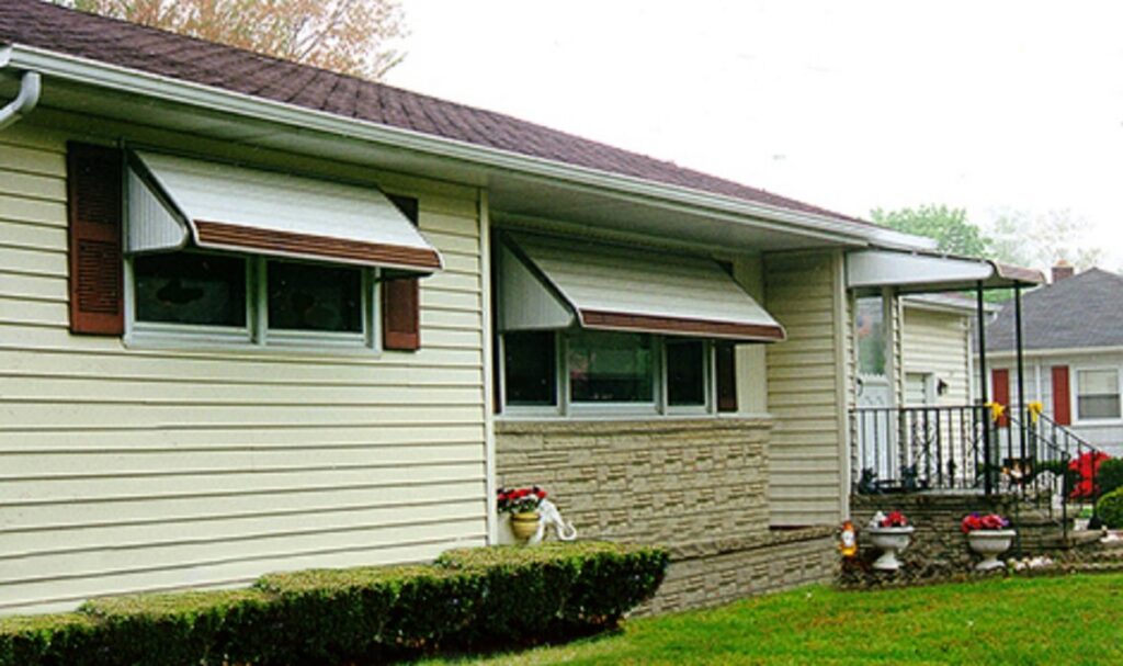 A house featuring newly installed window awnings, a service provided by Pocatello Handyman in Pocatello, ID