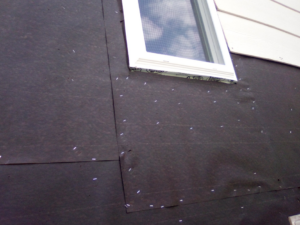 Close-up of house wrap installation on an exterior wall, a service by Picasso Handyman Painters in Wichita, KS.