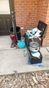 A pile of various household items and debris outside a home, awaiting junk removal by Westish Junk Removal LLC in Orlando, FL.