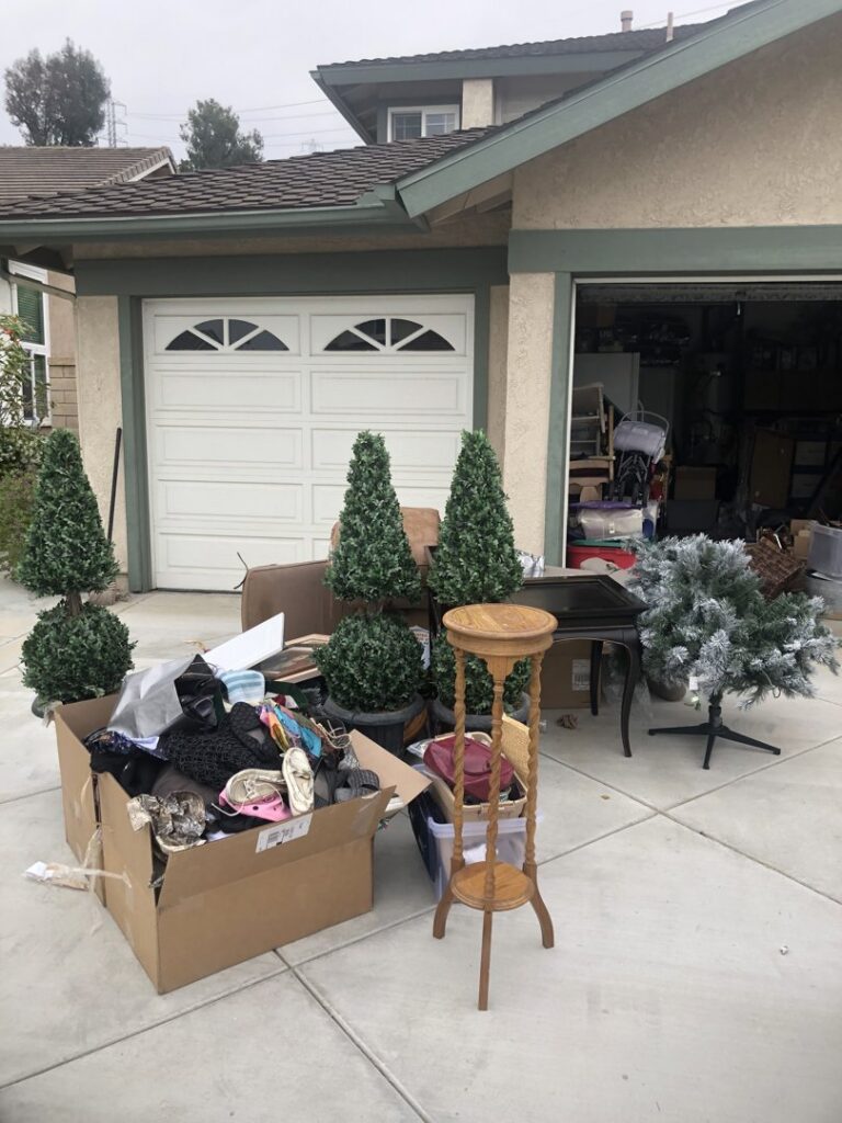 Various household junk items piled on a driveway for removal by The Junk Gentlemen in Anaheim, CA.
