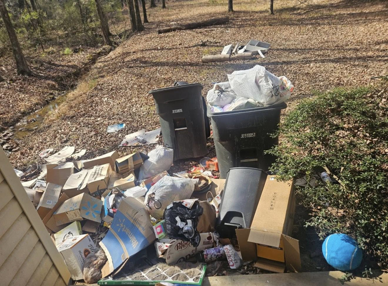 A large pile of household junk and overflowing trash bins awaiting removal by Pop & Son's Junk Removal in Montevallo, AL.