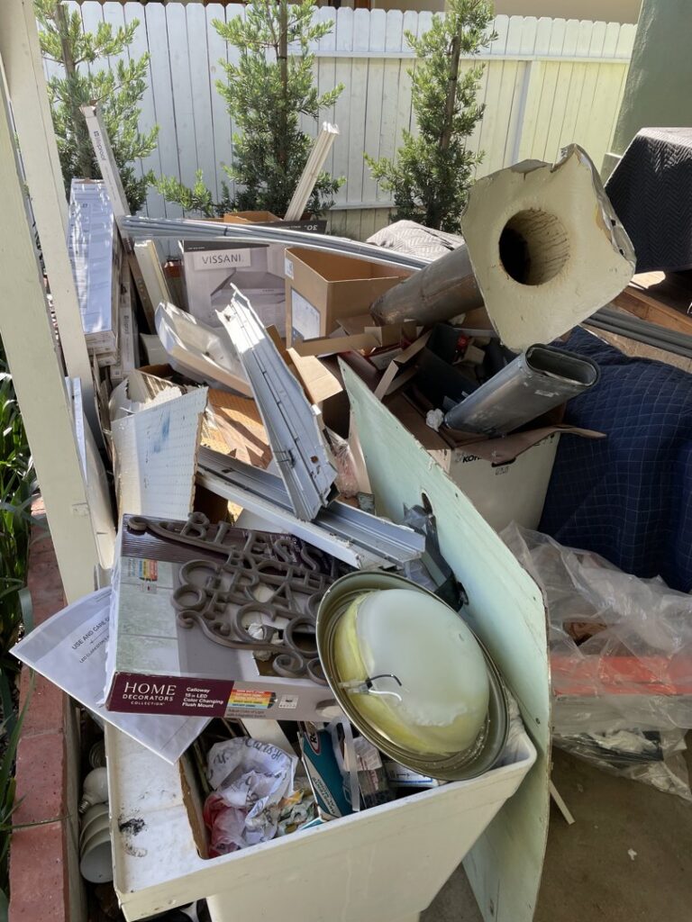 A large pile of assorted household junk and debris ready for removal by Elite Hauling & Junk Removal in San Diego, CA.