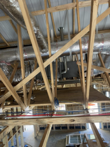 An HVAC air handler and ductwork being installed in an attic by ThermaPros in Leesburg, FL.