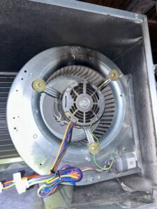 Close-up view of an HVAC blower motor inside a unit, indicating inspection or repair by Pollock HVAC & Electrical in Albany, GA