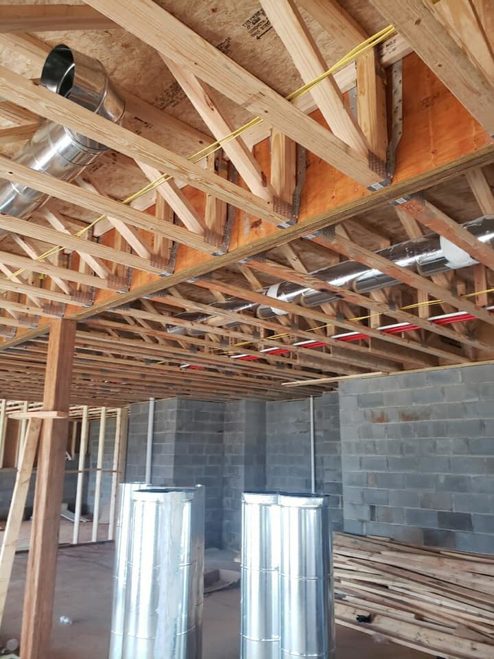 HVAC ducts and electrical wiring being installed in a new construction project by DMMC LLC in Kansas City, MO
