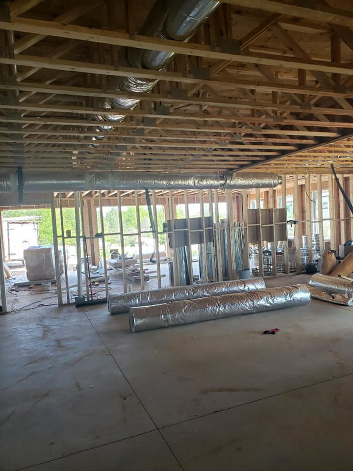 HVAC ductwork installation in a framed building under construction by DMMC LLC in Kansas City, MO