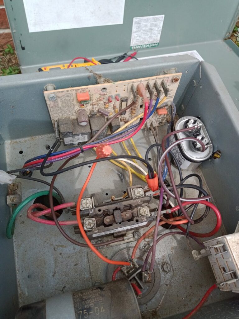 Close-up of an HVAC electrical control box with wiring and components, showing repair or maintenance by Pollock HVAC & Electrical in Albany, GA