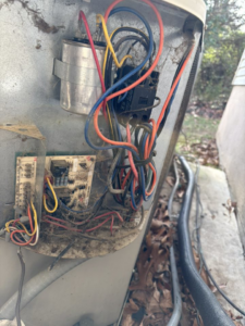 Internal electrical components and wiring of an HVAC unit being serviced by HomeFront Services LLC in Fayetteville, AR