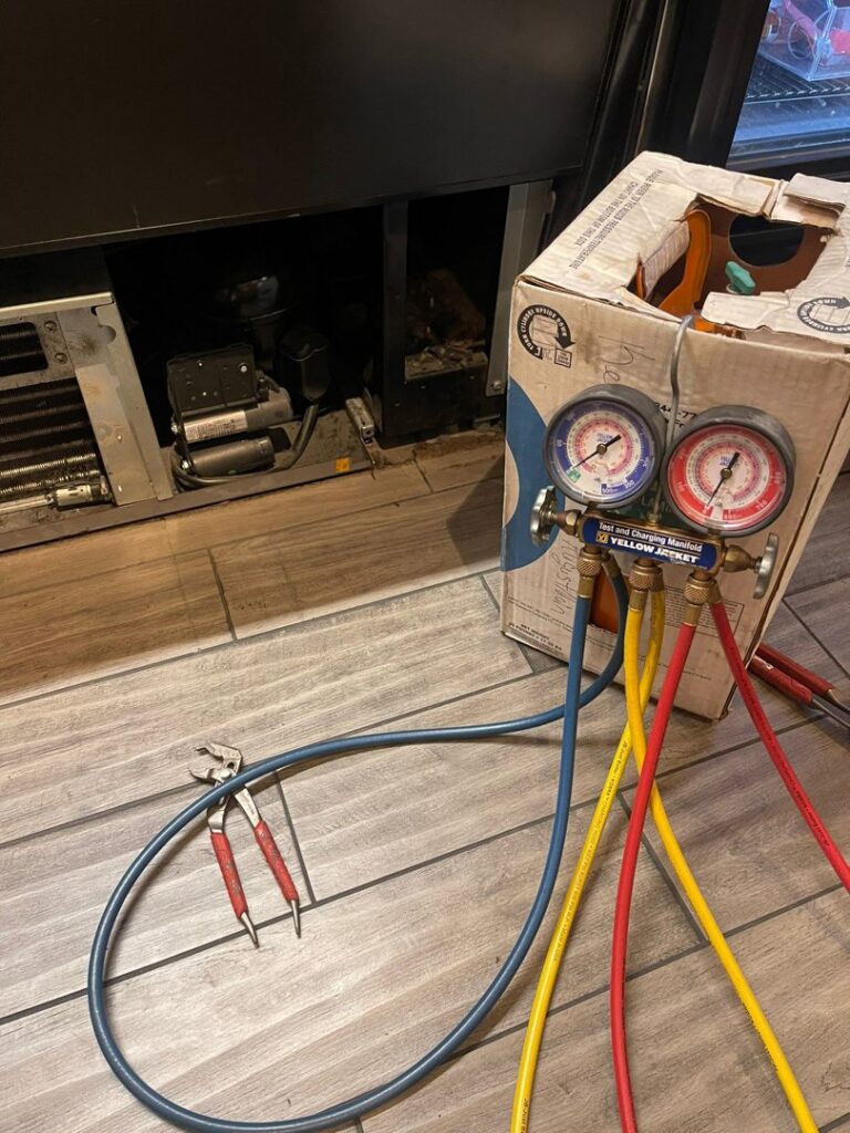 HVAC refrigeration gauges connected to a commercial unit during repair by DemoCraft Commercial Services in Everett, WA