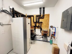HVAC and plumbing system installation in a utility room by Rochester Remodeling and Home Builders in Rochester, NY.