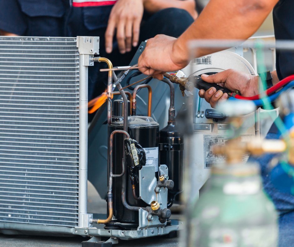 An HVAC technician brazing copper pipes on an air conditioning unit during a repair by Precision Air Conditioning & Heating, LLC in Memphis, TN.