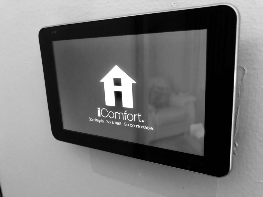 An iComfort smart thermostat installed on a wall, a service offered by Cold Comfort HVAC Services, LLC in Rockville, MD.